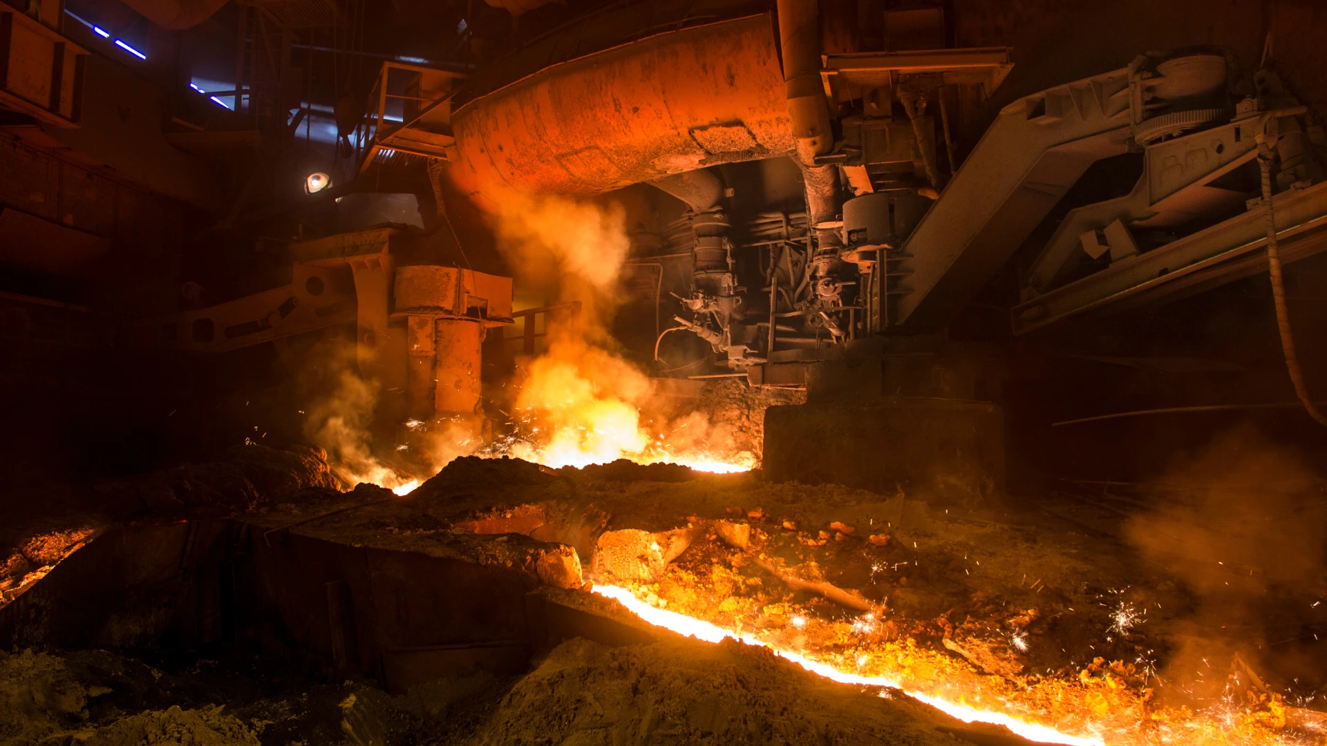 Coke supplier for steelworks – the steel smelting process in a blast furnace with visible molten metal and fire.