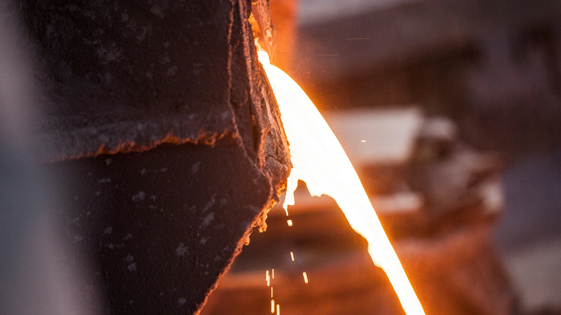 Dostawca koksu dla hut – strumień płynnego metalu wylewający się z pieca hutniczego w procesie produkcji stali.