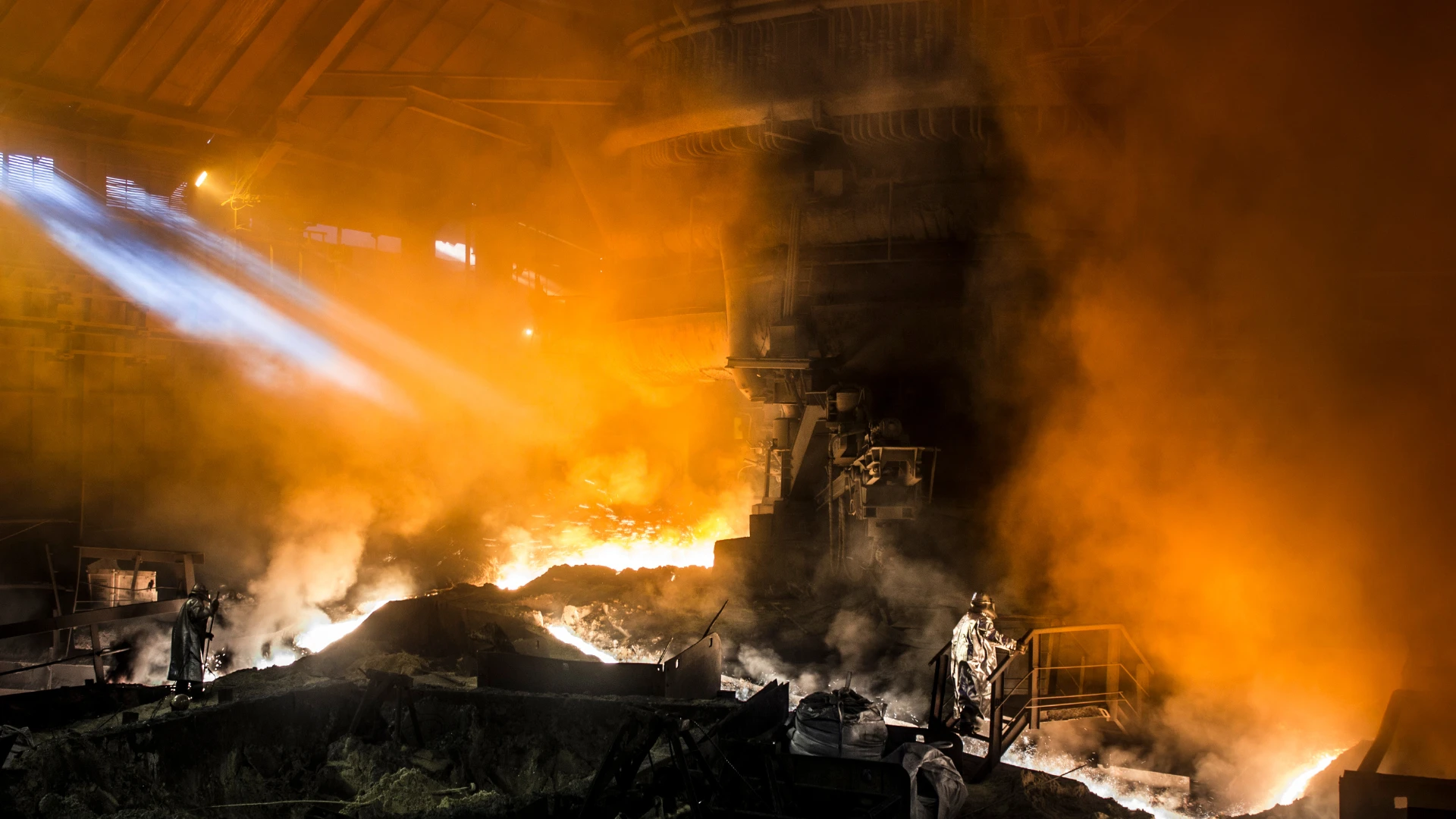 Metallurgical Coke Supplier – interior of a steel plant with an industrial furnace, glowing metallurgical coke during a metallurgical process, intense light and technological steam.