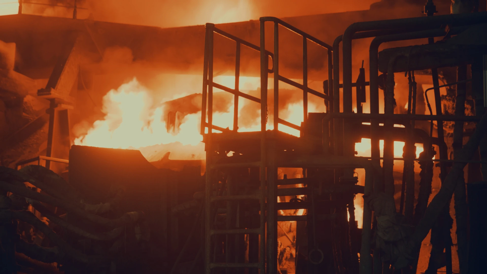 Metallurgical Coke Supplier – steelmaking installation with a glowing industrial furnace, intense fire and technological infrastructure during steel production.