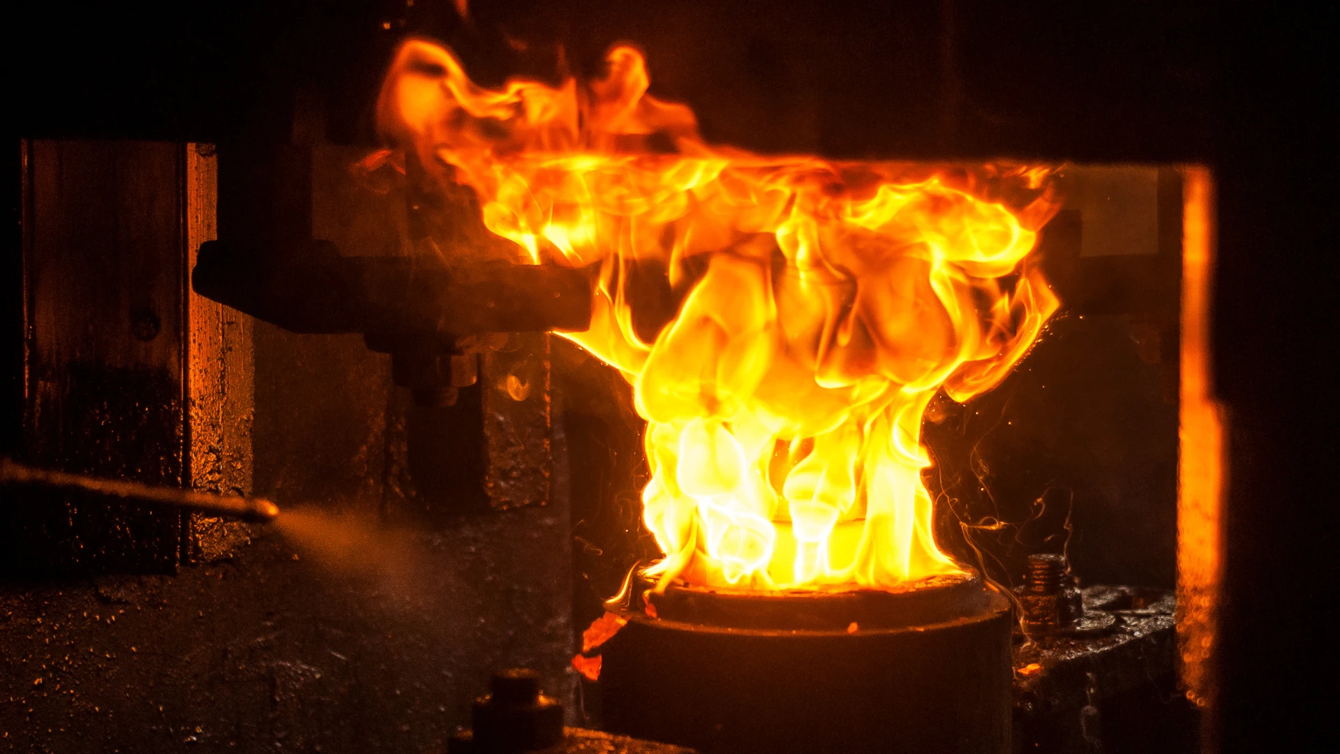 Metallurgical Coke Supplier – glowing coke burned in a metallurgical furnace, intense flames and a high-temperature process in steel production.