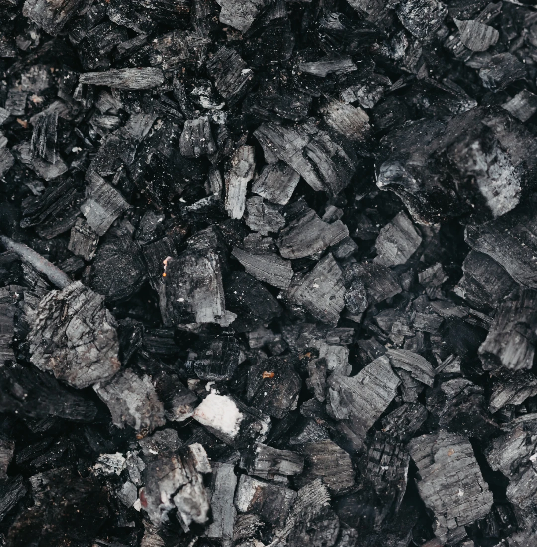A fragment of fine-grained energy coal, presenting the structure of the raw material used in industrial processes — PCI Coal Supplier.
