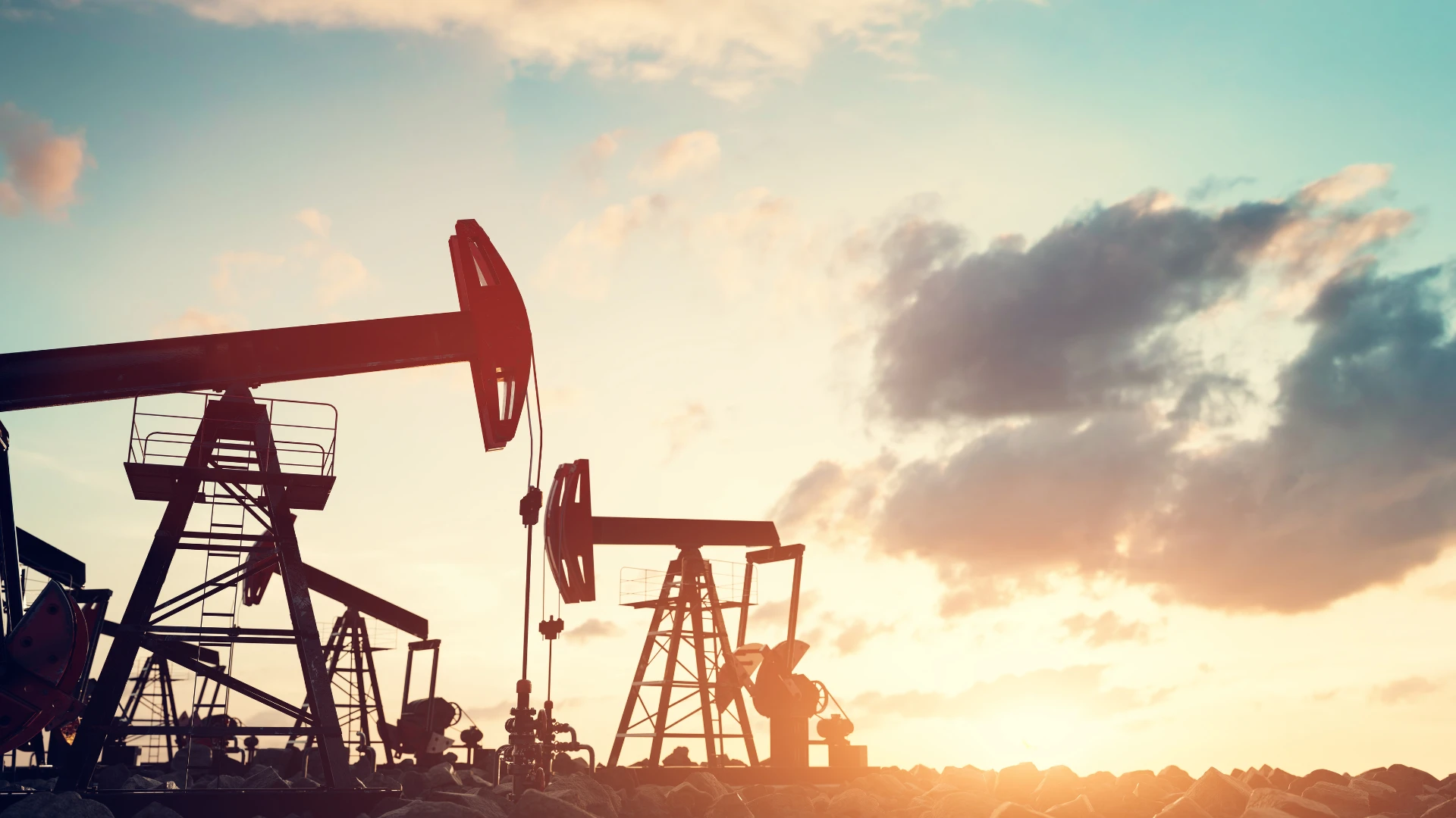 Distributor of Solid Fuels and Energy Raw Materials – oil extraction pumps operating at sunset against the backdrop of the sky.