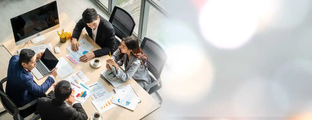 Work in the energy resources industry – a team of specialists analyzing reports and market data during a meeting in the office.