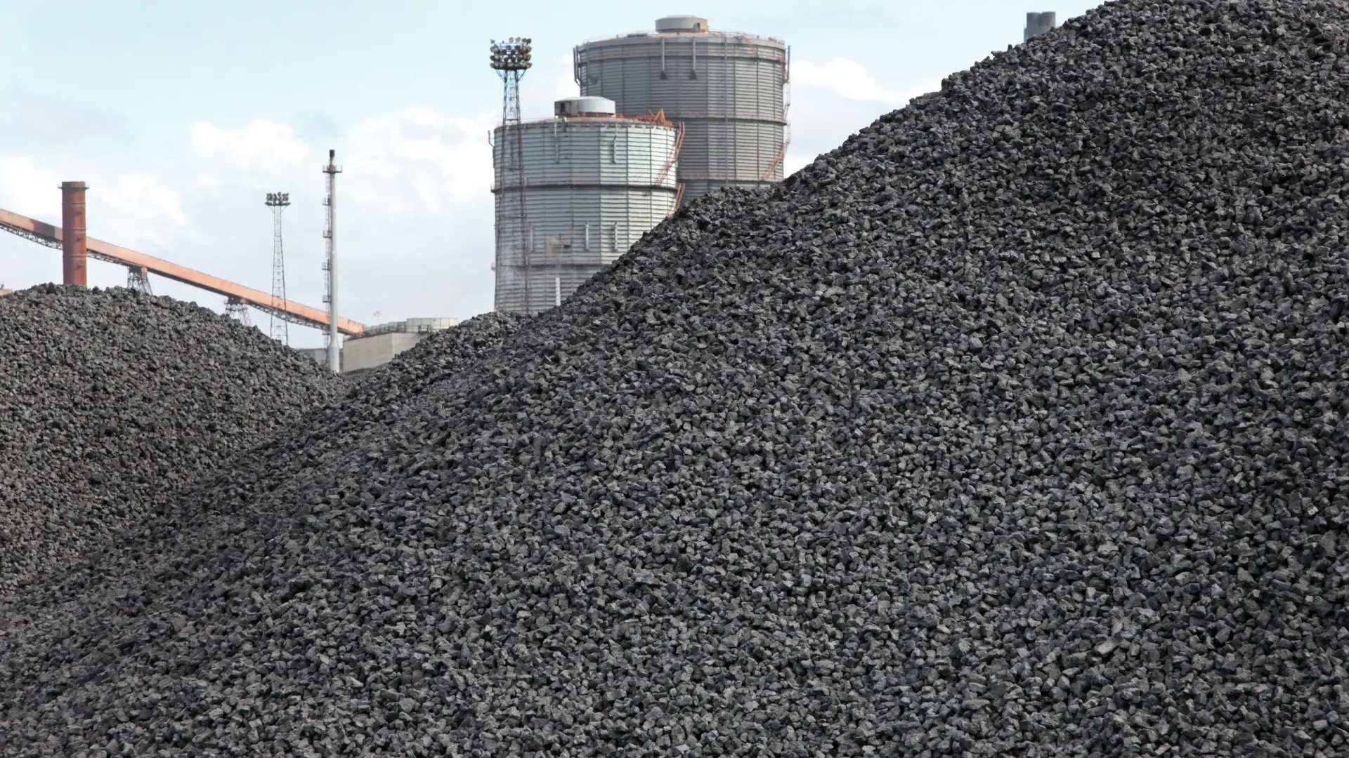 Coke sales – large piles of coke at the storage yard near the coking plant, industrial fuel ready for loading and transport
