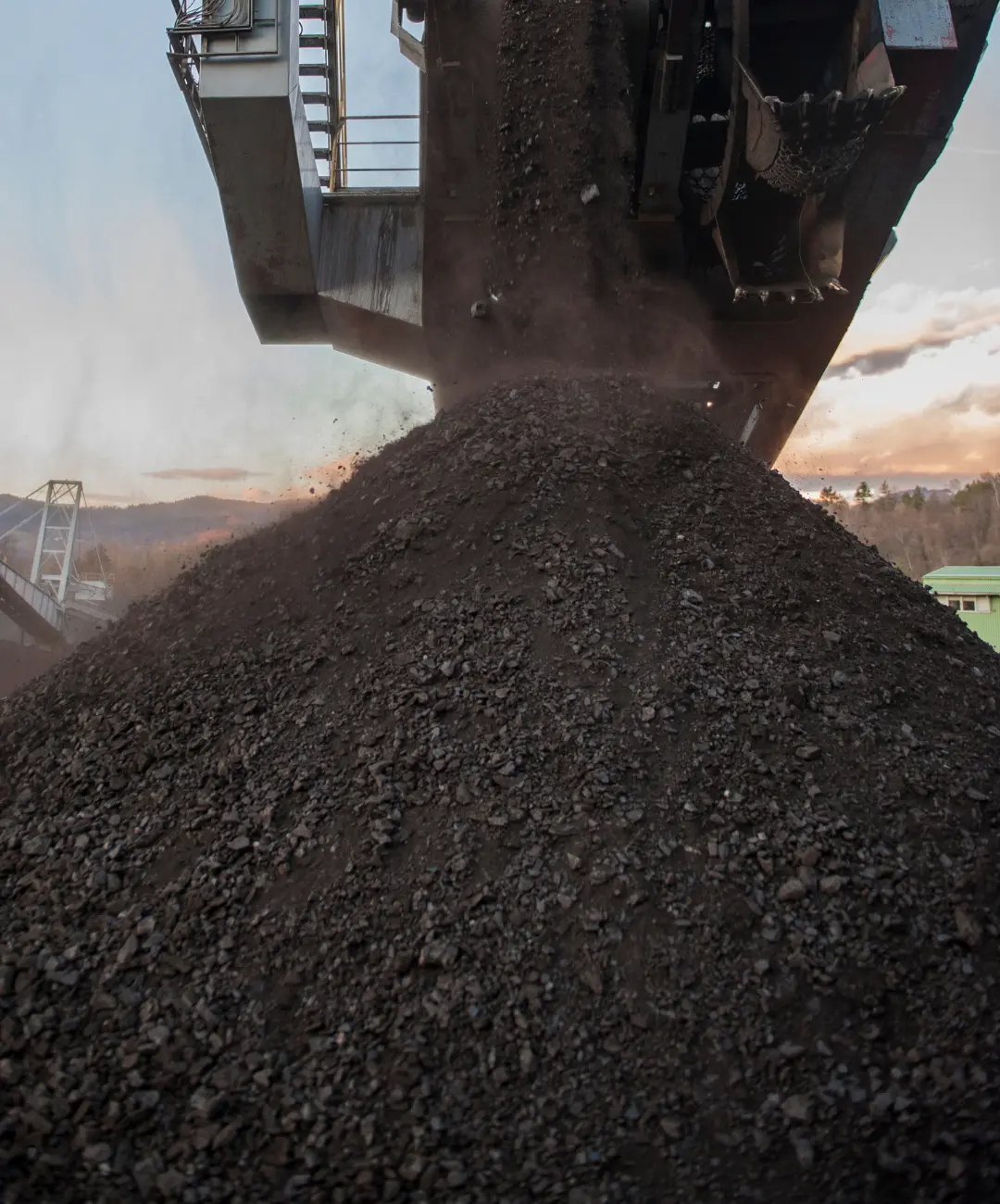 Coke sales – a stacker unloads coke granules onto a high pile in the storage yard